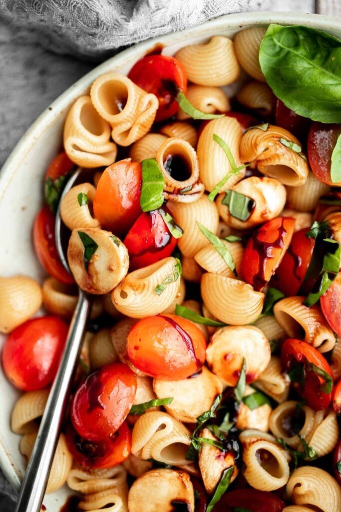 Bright and colorful caprese pasta salad is the ultimate summer side dish. It's fresh, light, and loaded with vibrant summer flavors. Quick and easy too! | aheadofthyme.com