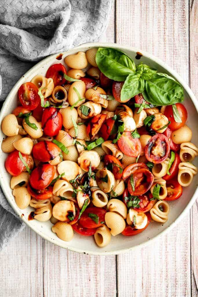 Bright and colorful caprese pasta salad is the ultimate summer side dish. It's fresh, light, and loaded with vibrant summer flavors. Quick and easy too! | aheadofthyme.com