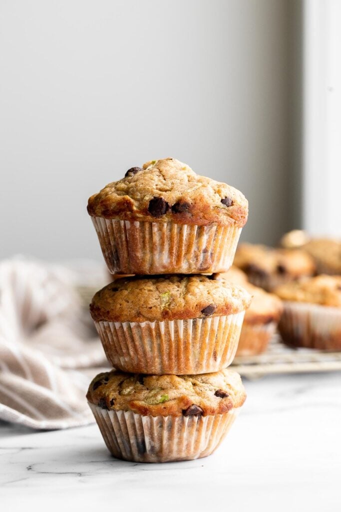 Chocolate chip zucchini muffins are moist, fluffy, and delicious. They are made healthier with fresh zucchini and yogurt which also adds amazing texture. | aheadofthyme.com