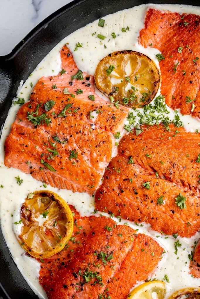 Creamy garlic salmon is a quick easy one-pan meal ready in under 30 minutes, with seared flaky tender salmon tossed in a delicious creamy garlic sauce. | aheadofthyme.com