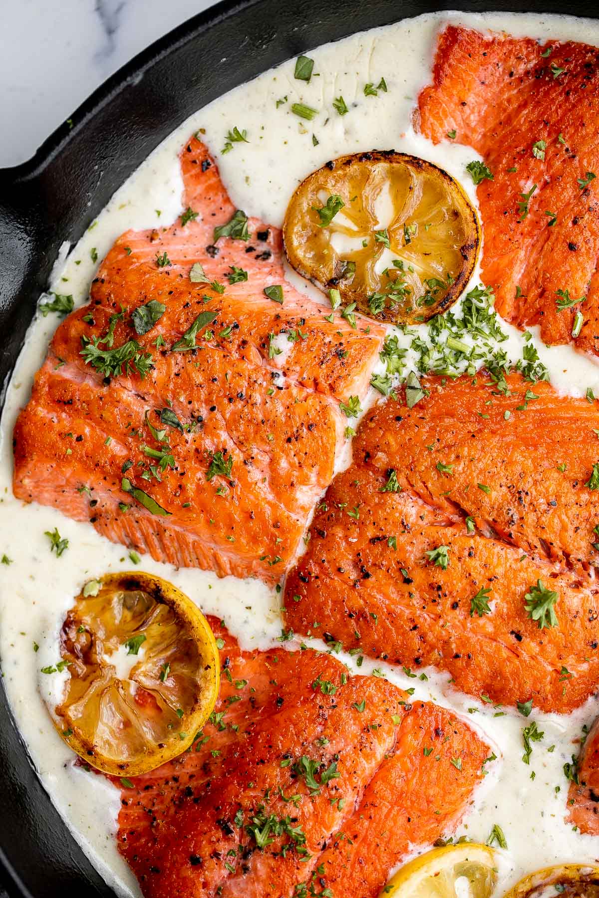 Creamy garlic salmon is a quick easy one-pan meal ready in under 30 minutes, with seared flaky tender salmon tossed in a delicious creamy garlic sauce. | aheadofthyme.com
