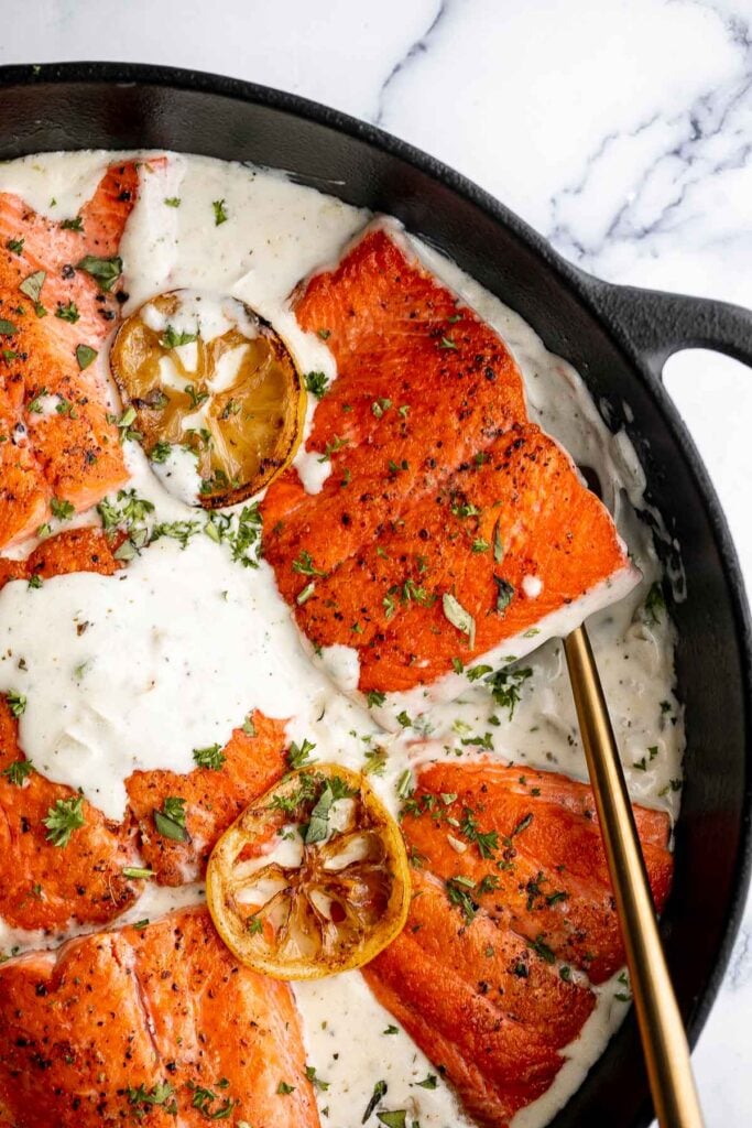 Creamy garlic salmon is a quick easy one-pan meal ready in under 30 minutes, with seared flaky tender salmon tossed in a delicious creamy garlic sauce. | aheadofthyme.com