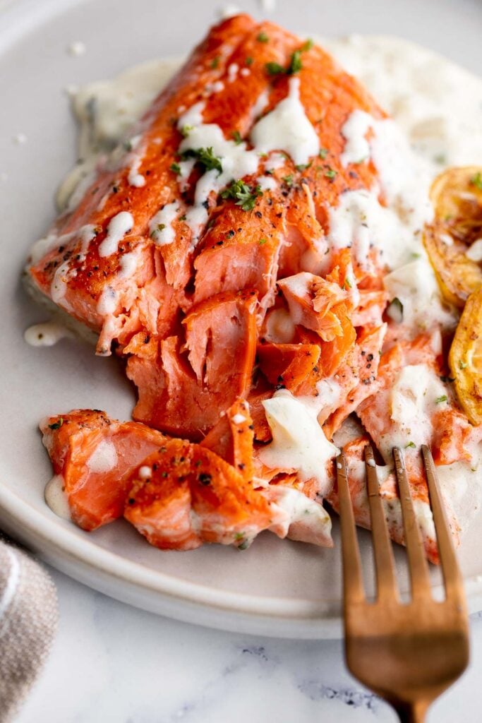 Creamy garlic salmon is a quick easy one-pan meal ready in under 30 minutes, with seared flaky tender salmon tossed in a delicious creamy garlic sauce. | aheadofthyme.com