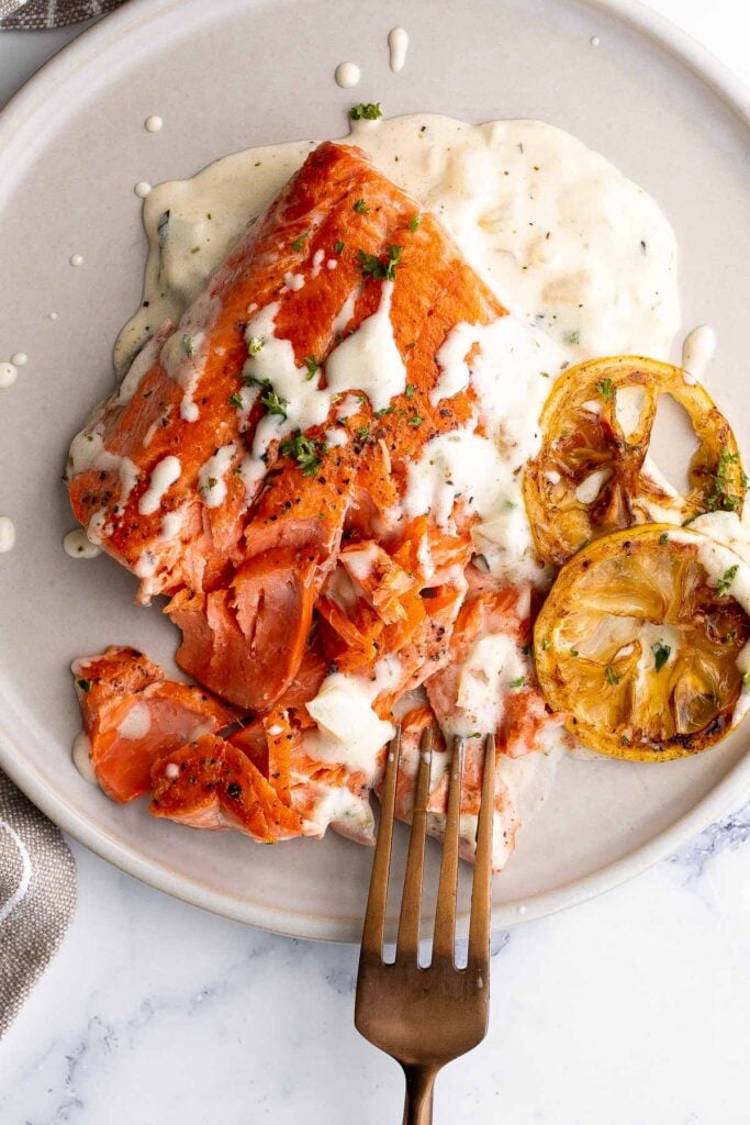 Creamy garlic salmon is a quick easy one-pan meal ready in under 30 minutes, with seared flaky tender salmon tossed in a delicious creamy garlic sauce. | aheadofthyme.com