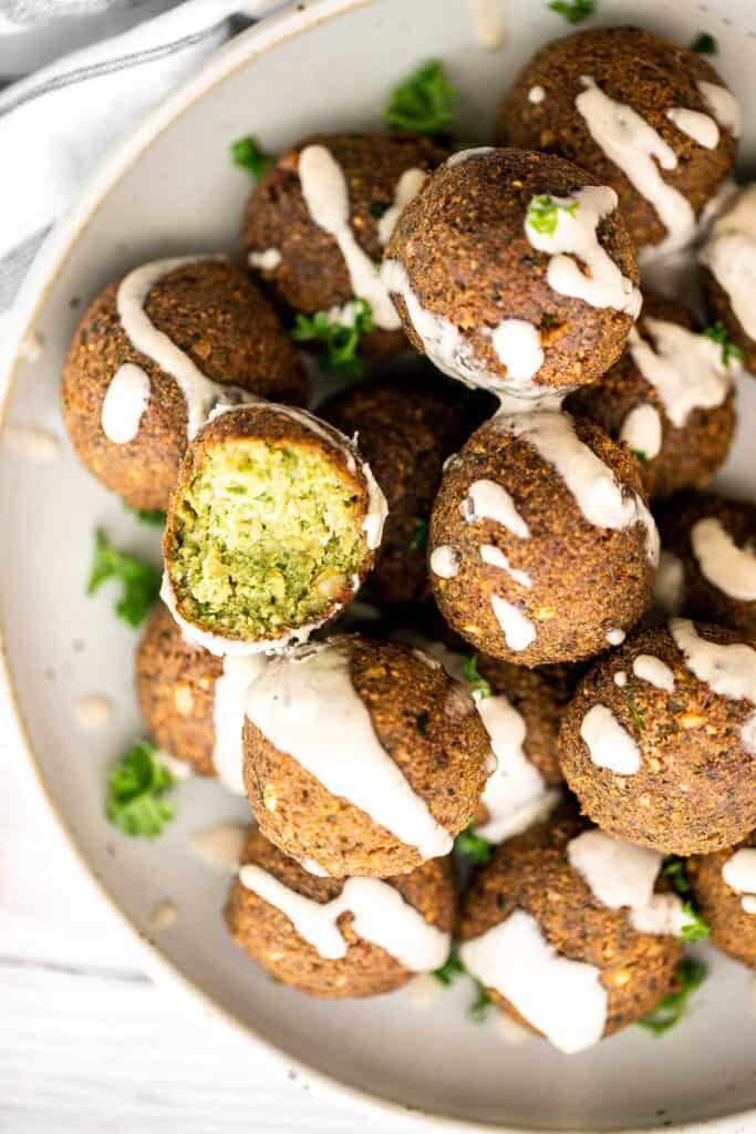 Homemade falafel are delicious, golden brown and crispy on the outside, fluffy tender and soft inside. Plus, they're vegan, loaded with plant-based protein. | aheadofthyme.com