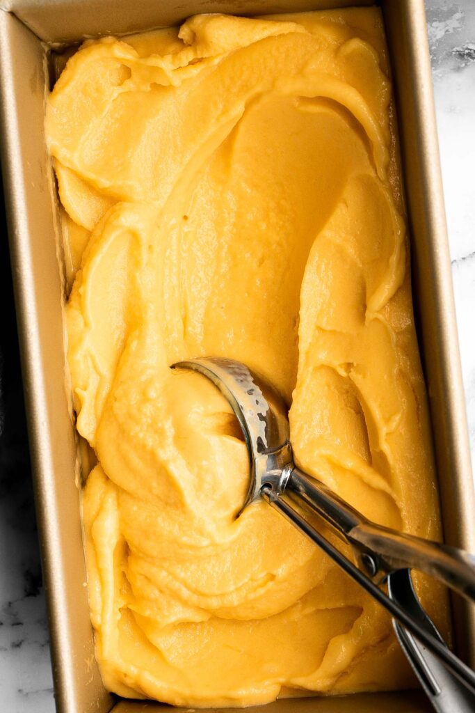 Mango frozen yogurt is a healthy, creamy, fruity, and refreshing frozen treat that's easy to make in minutes with a few ingredients and no refined sugar. | aheadofthyme.com