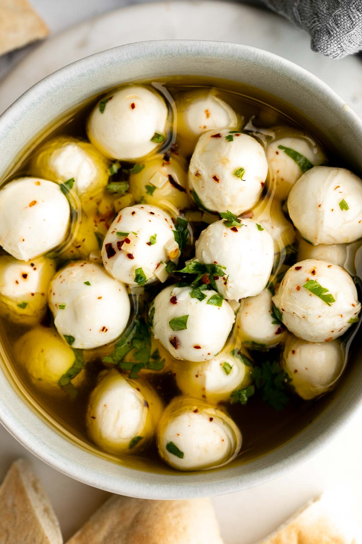 Marinated mozzarella balls is a delicious and simple yet stunning appetizer, made with fresh bocconcini soaked in olive oil, garlic, and fresh herbs. | aheadofthyme.com