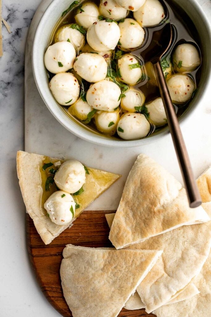 Marinated mozzarella balls is a delicious and simple yet stunning appetizer, made with fresh bocconcini soaked in olive oil, garlic, and fresh herbs. | aheadofthyme.com