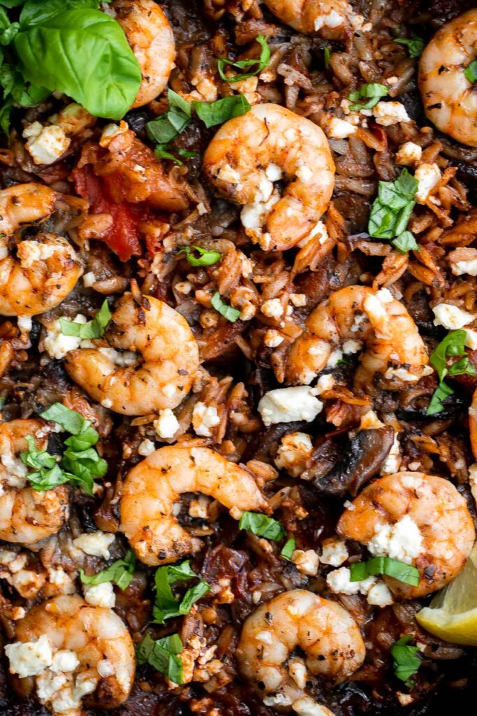 Mediterranean baked shrimp orzo is a complete wholesome one pot meal with delicious sautéed vegetables, juicy shrimp, and orzo pasta. Make it in 30 minutes. | aheadofthyme.com