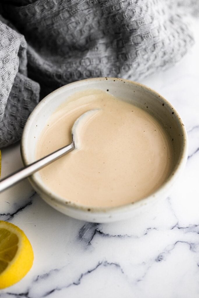 Tahini sauce is creamy, smooth, nutty, and flavorful. Made in just 5 minutes with a handful of ingredients, add this gluten-free, vegan sauce on everything. | aheadofthyme.com