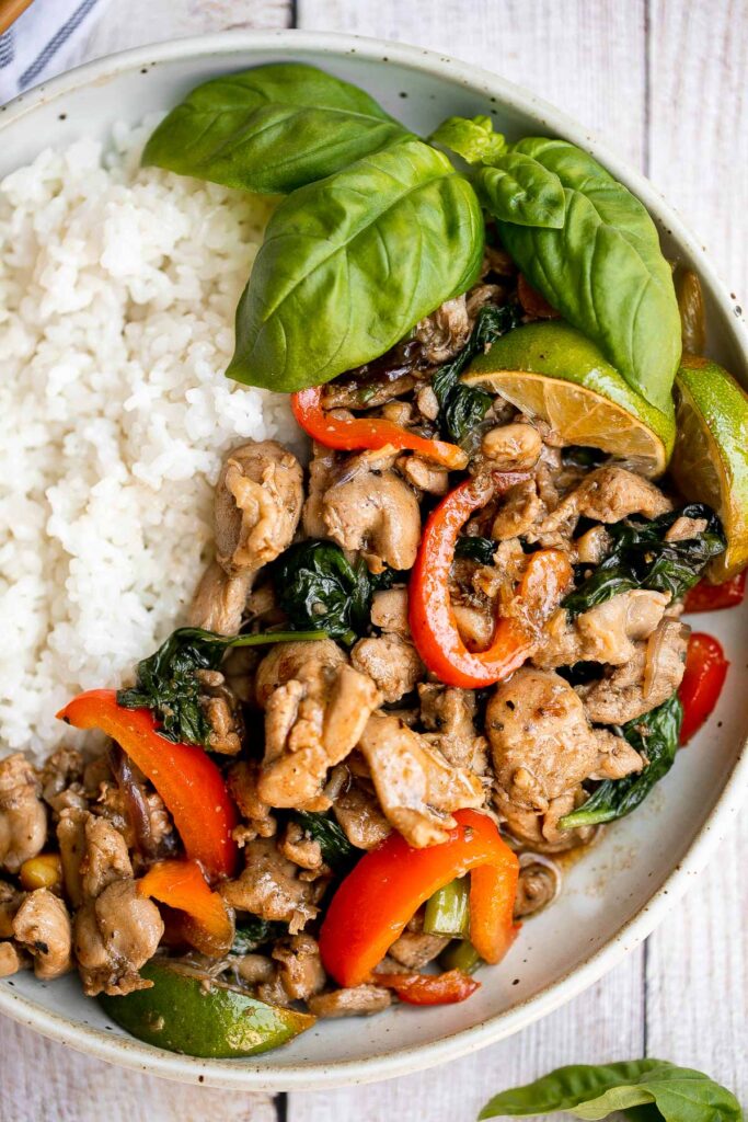 Better than takeout, Thai basil chicken with a delicious homemade sauce is a quick and easy, light and fresh chicken stir fry that is ready in 25 minutes. | aheadofthyme.com