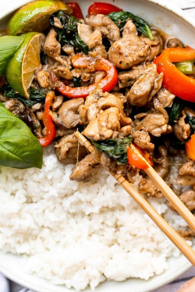 Better than takeout, Thai basil chicken with a delicious homemade sauce is a quick and easy, light and fresh chicken stir fry that is ready in 25 minutes. | aheadofthyme.com