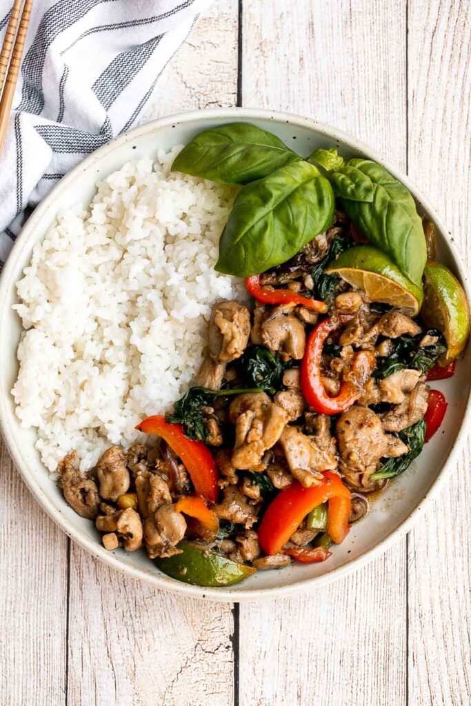 Better than takeout, Thai basil chicken with a delicious homemade sauce is a quick and easy, light and fresh chicken stir fry that is ready in 25 minutes. | aheadofthyme.com
