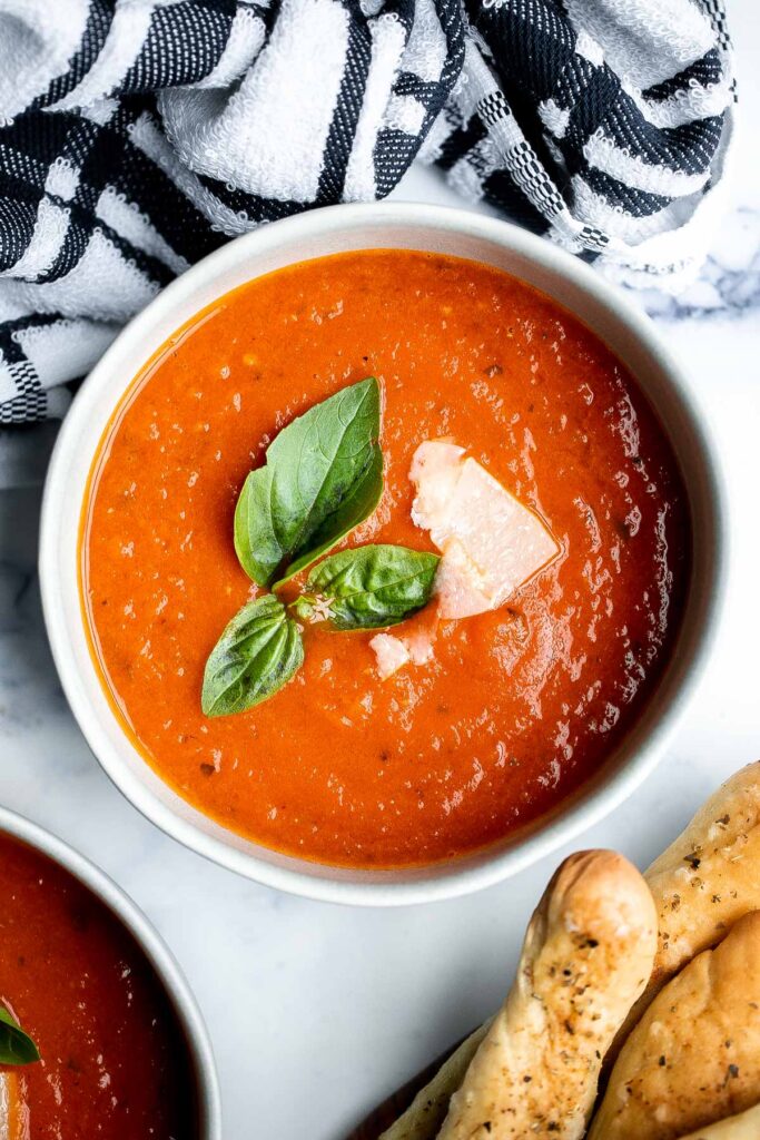 Homemade tomato basil soup is comforting, rich, and smooth. This cozy soup is easy, flavourful, and nourishing, making it so much better than canned. | aheadofthyme.com