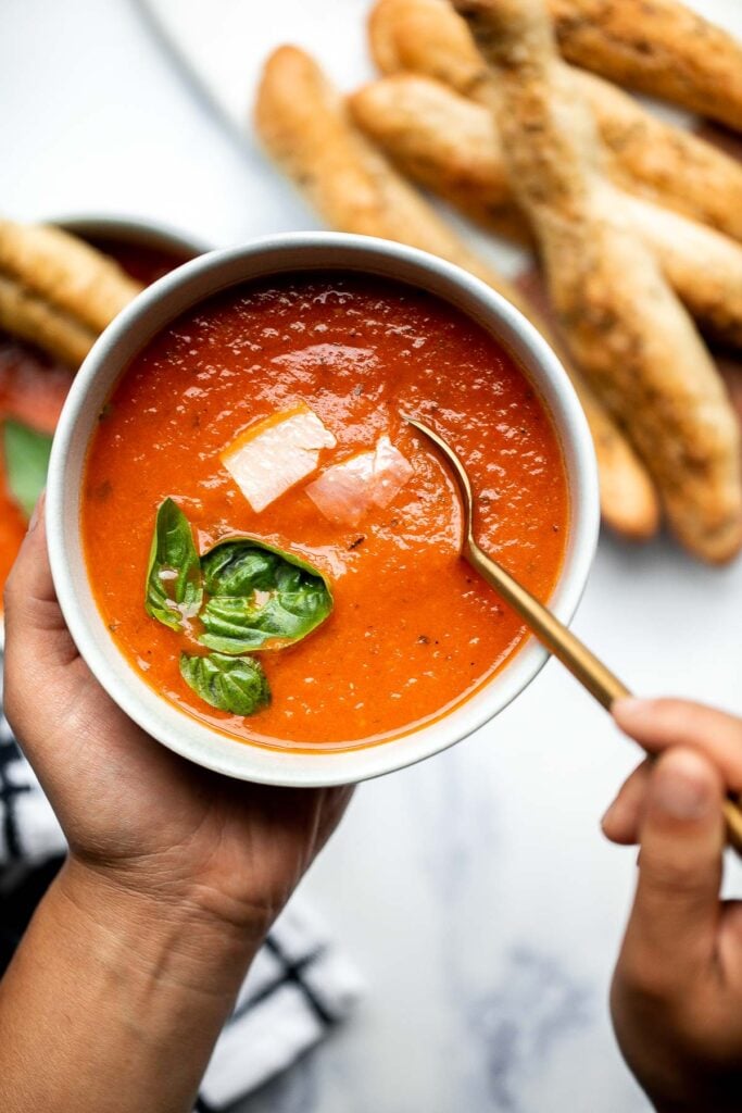 Homemade tomato basil soup is comforting, rich, and smooth. This cozy soup is easy, flavourful, and nourishing, making it so much better than canned. | aheadofthyme.com