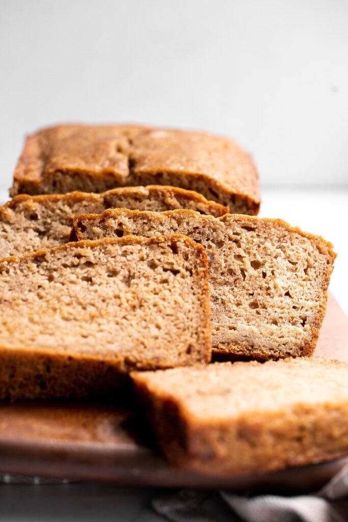 Homemade applesauce bread is fluffy, moist, and delicious. Loaded with fall flavors that transforms your favorite snack into a loaf cake. | aheadofthyme.com