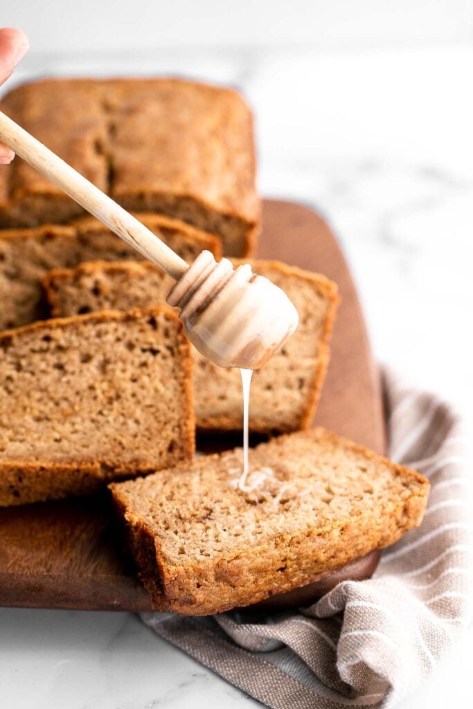 Homemade applesauce bread is fluffy, moist, and delicious. Loaded with fall flavors that transforms your favorite snack into a loaf cake. | aheadofthyme.com