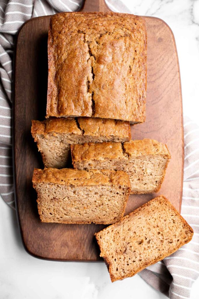 Homemade applesauce bread is fluffy, moist, and delicious. Loaded with fall flavors that transforms your favorite snack into a loaf cake. | aheadofthyme.com