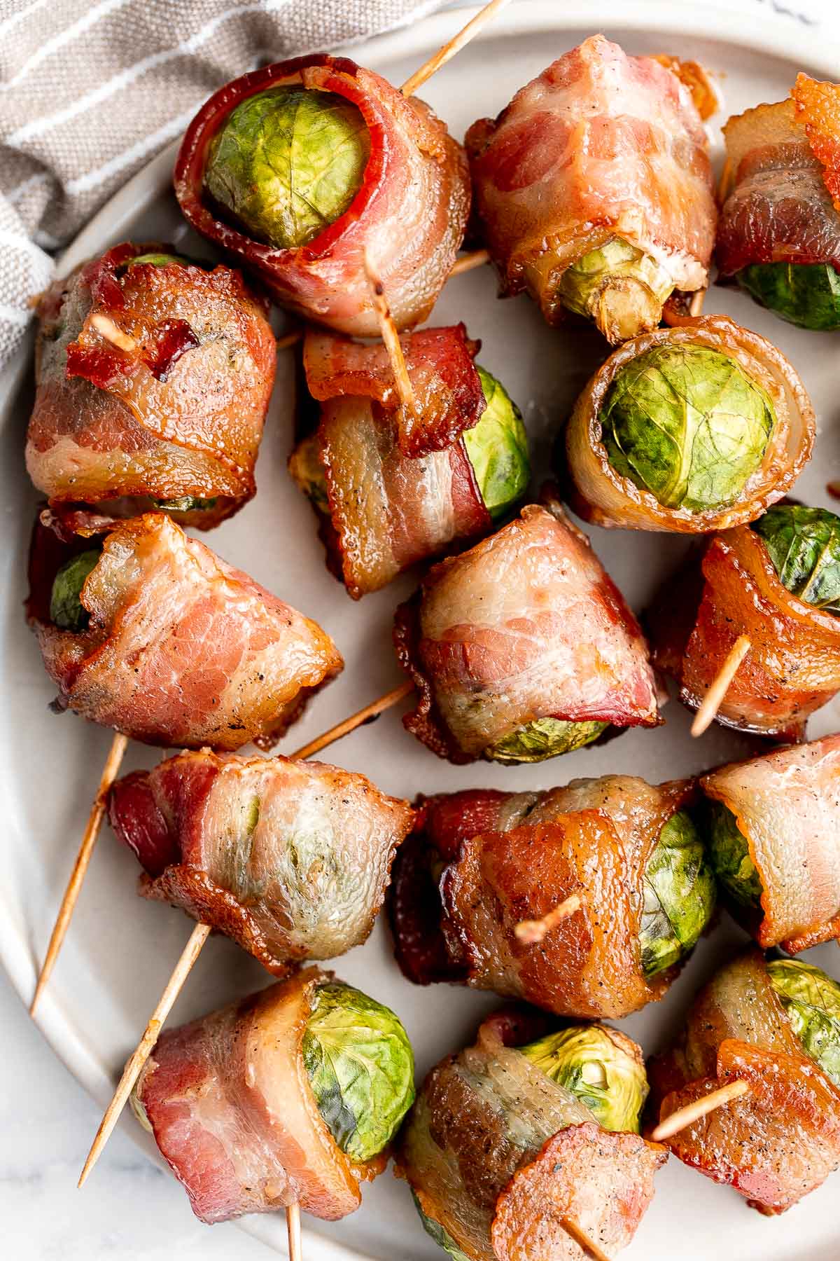 Bacon wrapped brussels sprouts are the sweet, savory, and salty appetizer that you need at your next holiday gathering this fall. Simple and easy to make. | aheadofthyme.com