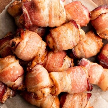 Bacon wrapped chicken bites are one of the best appys ever — well seasoned tender juicy chicken is wrapped in bacon and oven-baked to crisp perfection. | aheadofthyme.com