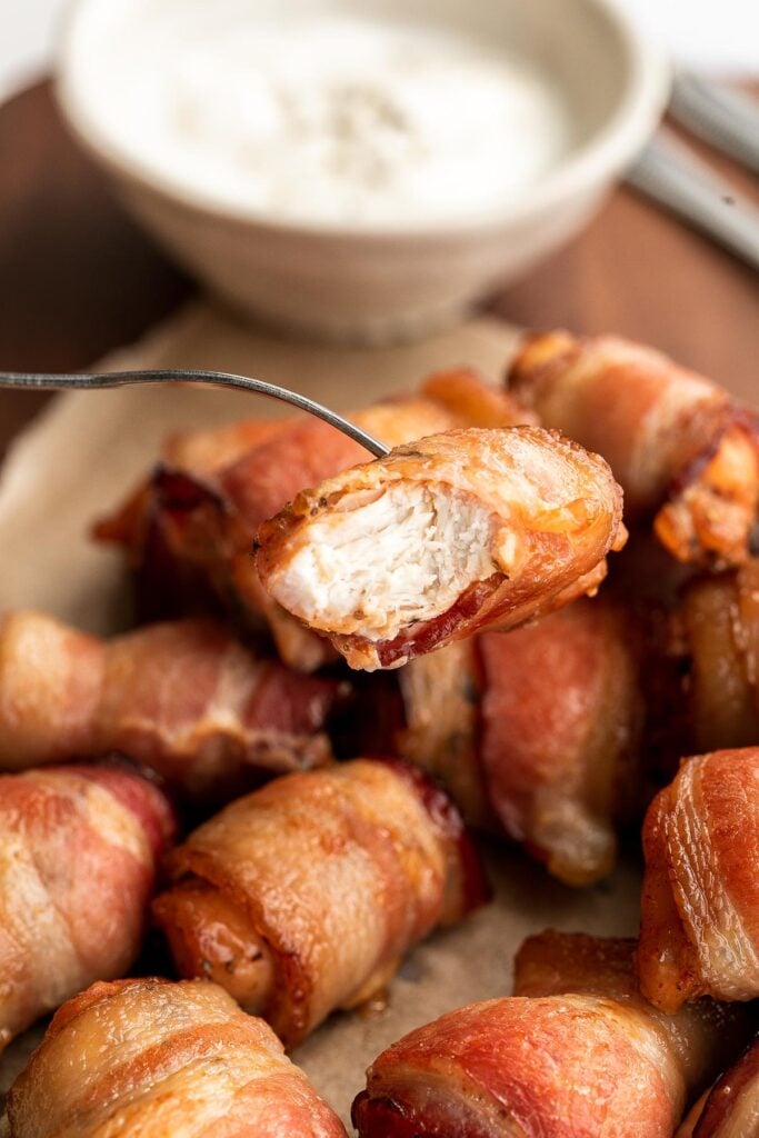 Bacon wrapped chicken bites are one of the best appys ever — well seasoned tender juicy chicken is wrapped in bacon and oven-baked to crisp perfection. | aheadofthyme.com