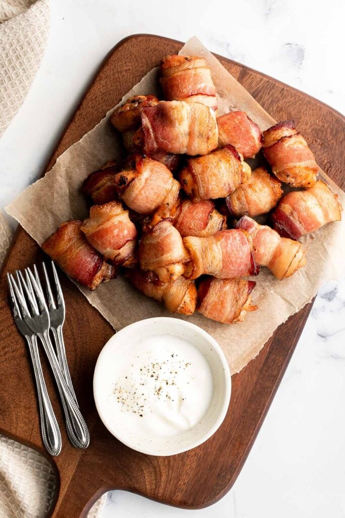 Bacon wrapped chicken bites are one of the best appys ever — well seasoned tender juicy chicken is wrapped in bacon and oven-baked to crisp perfection. | aheadofthyme.com