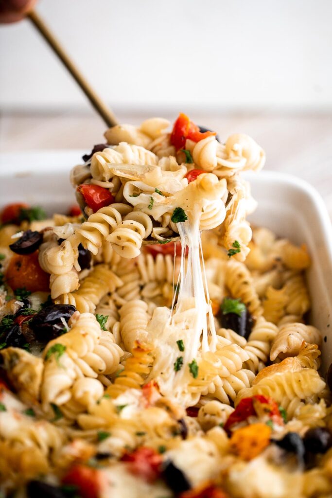 Baked Mediterranean pasta is simple, flavorful, and vibrant, loaded with fresh tomatoes, artichoke hearts, and olives, and topped with mozzarella cheese. | aheadofthyme.com