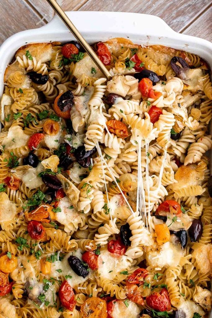 Baked Mediterranean pasta is simple, flavorful, and vibrant, loaded with fresh tomatoes, artichoke hearts, and olives, and topped with mozzarella cheese. | aheadofthyme.com