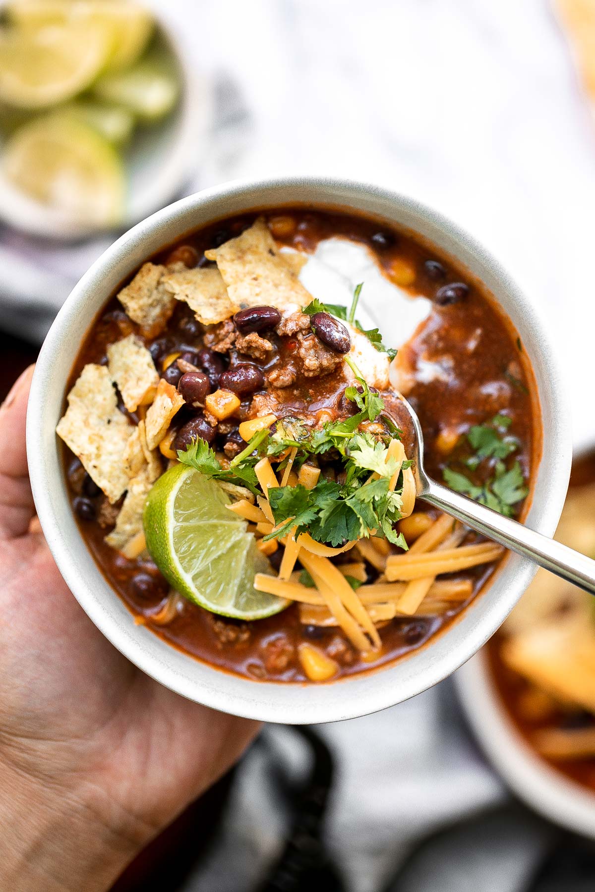 Beef taco soup is a delicious take on tacos, transforming it into a hearty, wholesome, filling soup topped with all the taco fixings. Ready in 30 minutes. | aheadofthyme.com