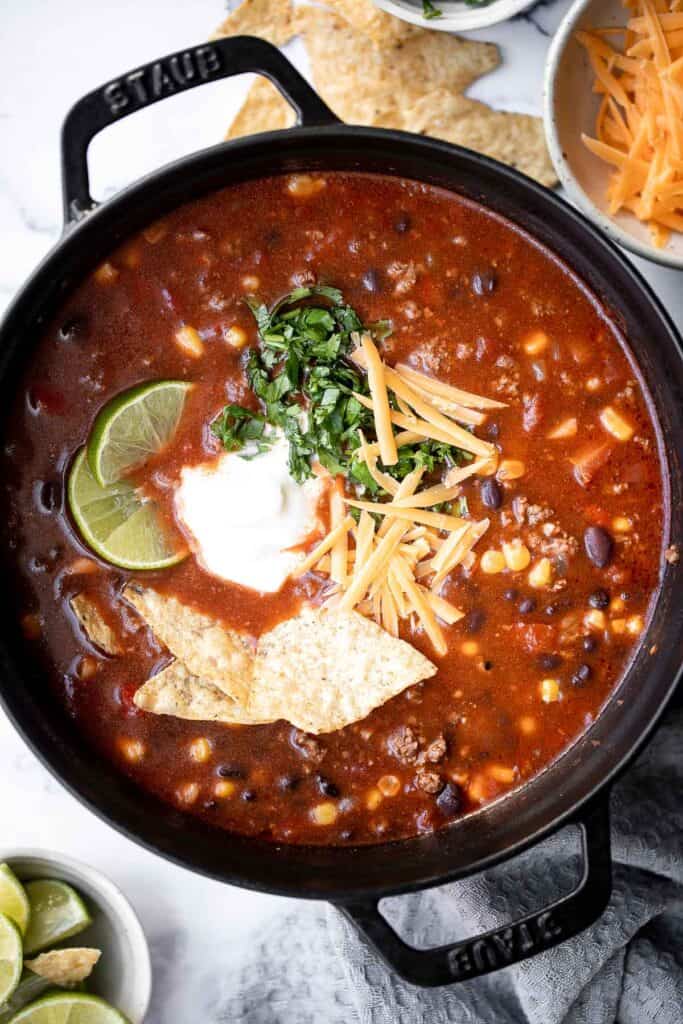 Beef taco soup is a delicious take on tacos, transforming it into a hearty, wholesome, filling soup topped with all the taco fixings. Ready in 30 minutes. | aheadofthyme.com