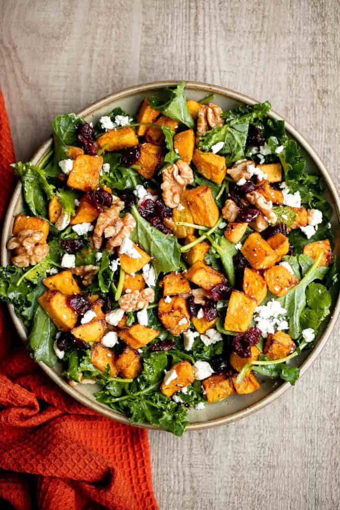 Butternut squash salad is a light meal that's loaded with fall flavors — roasted butternut squash, baby kale, walnuts, dried cranberries, and feta. | aheadofthyme.com
