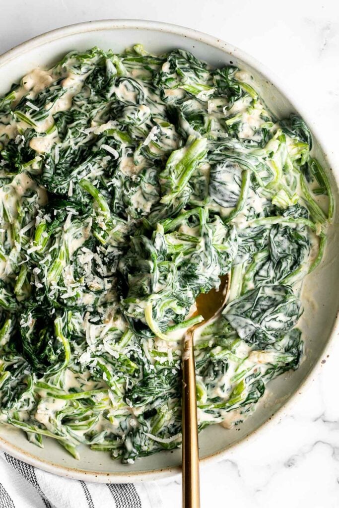Creamed spinach is a rich, creamy, and delicious side dish to make this fall. Easy to make ahead and reheats well — perfect for Thanksgiving holiday dinner. | aheadofthyme.com
