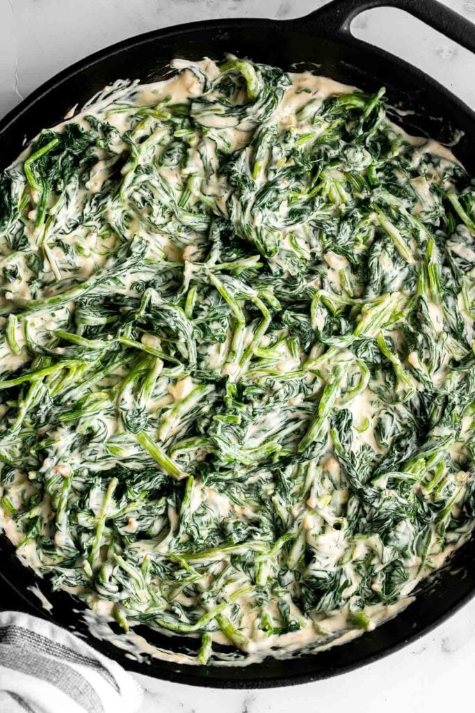 Creamed spinach is a rich, creamy, and delicious side dish to make this fall. Easy to make ahead and reheats well — perfect for Thanksgiving holiday dinner. | aheadofthyme.com