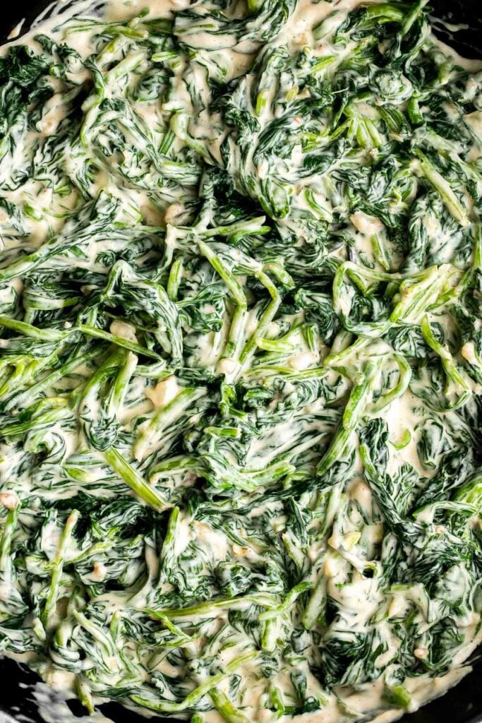 Creamed spinach is a rich, creamy, and delicious side dish to make this fall. Easy to make ahead and reheats well — perfect for Thanksgiving holiday dinner. | aheadofthyme.com