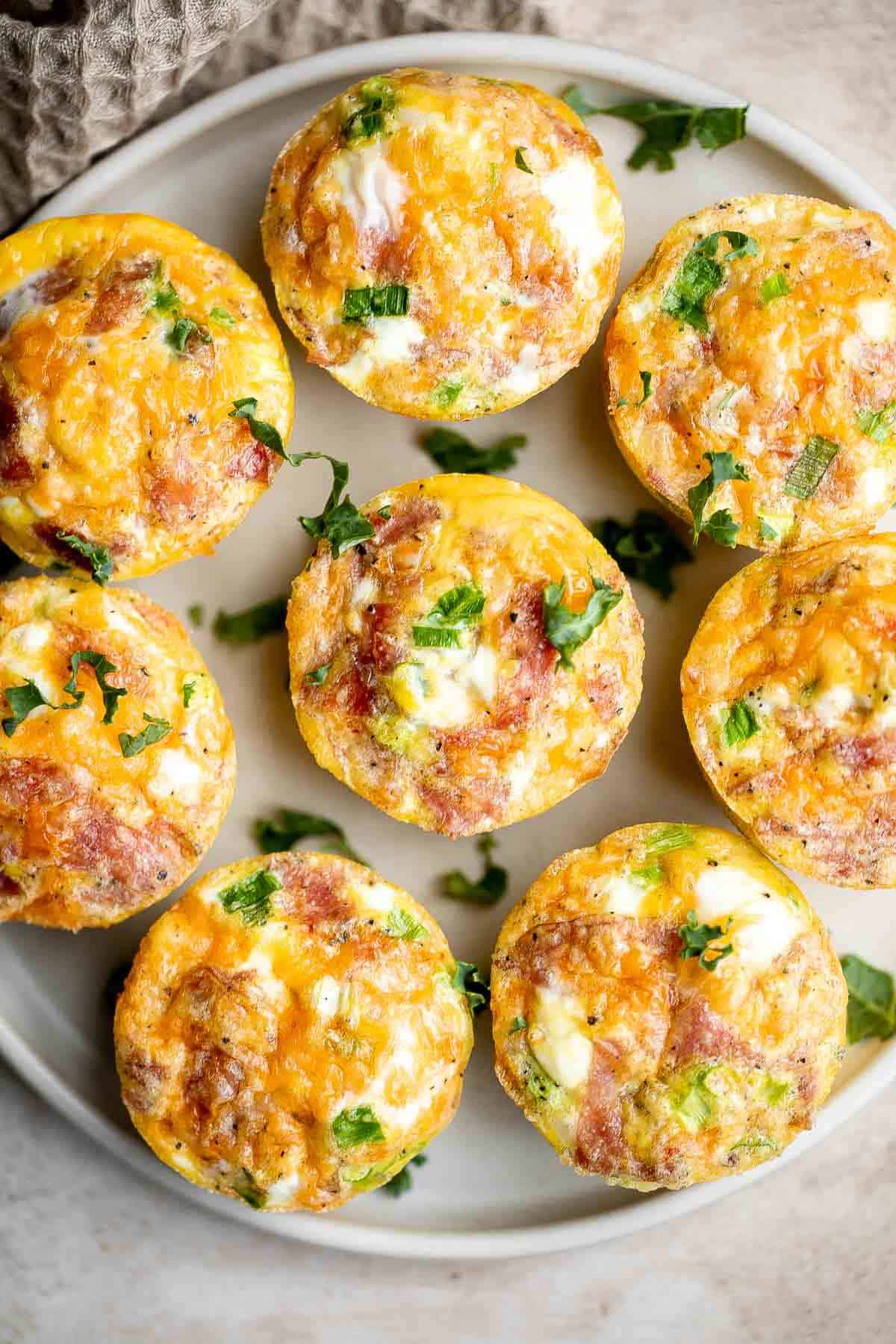 Egg muffins are a quick and easy way to meal prep breakfast on-the-go, loaded with cheddar cheese, bacon or salami, and green onions. Make 12 in 30 minutes. | aheadofthyme.com