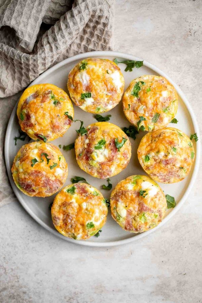 Egg muffins are a quick and easy way to meal prep breakfast on-the-go, loaded with cheddar cheese, bacon or salami, and green onions. Make 12 in 30 minutes. | aheadofthyme.com