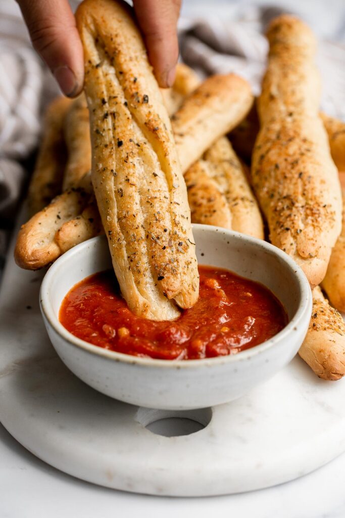 Soft garlic breadsticks are fluffy, airy, buttery, and delicious. They're an easy recipe that is perfect for beginners at baking bread. | aheadofthyme.com