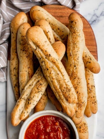 Soft garlic breadsticks are fluffy, airy, buttery, and delicious. They're an easy recipe that is perfect for beginners at baking bread. | aheadofthyme.com