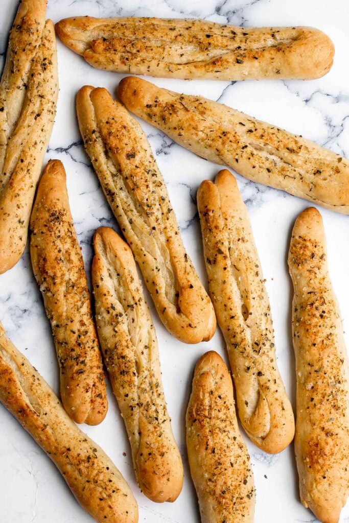 Soft garlic breadsticks are fluffy, airy, buttery, and delicious. They're an easy recipe that is perfect for beginners at baking bread. | aheadofthyme.com