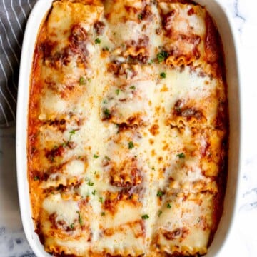 Lasagna roll ups are a twist on traditional lasagna. Lasagna noodles are filled with cheese and meat sauce and rolled up. Make ahead and freezer-friendly! | aheadofthyme.com