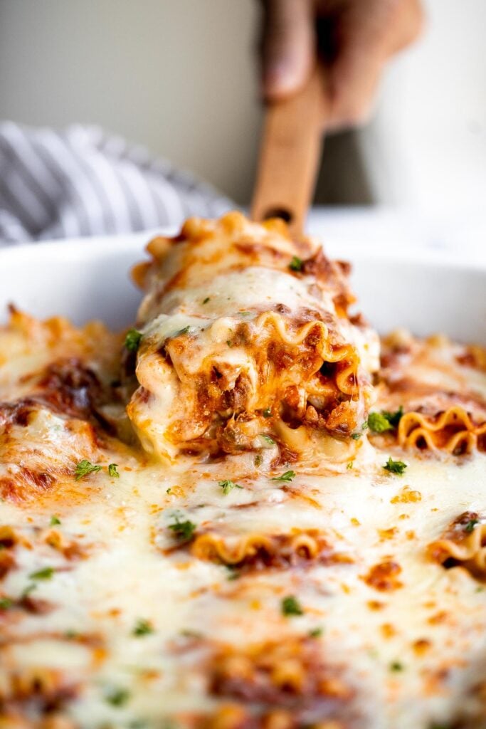 Lasagna roll ups are a twist on traditional lasagna. Lasagna noodles are filled with cheese and meat sauce and rolled up. Make ahead and freezer-friendly! | aheadofthyme.com