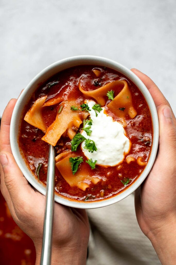 Lasagna soup is a twist on a classic Italian recipe with all the same delicious comforting flavors in the form of a hearty one pot soup. | aheadofthyme.com