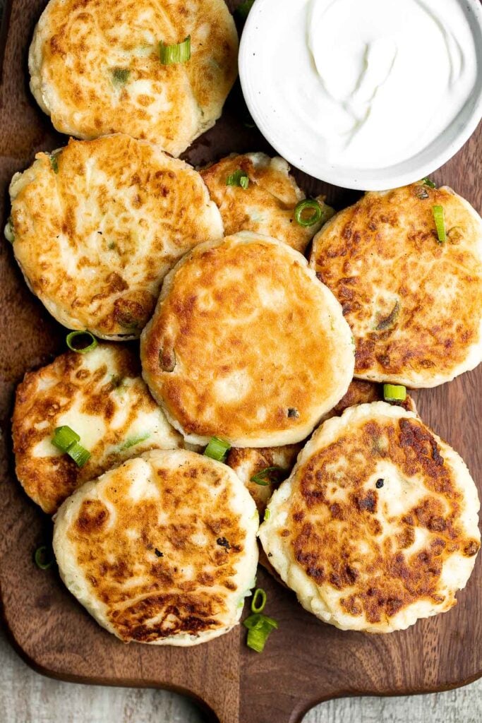 Mashed potato cakes are light and fluffy inside, crispy golden outside, and so delicious and flavorful. The best way to use up leftover mashed potatoes! | aheadofthyme.com