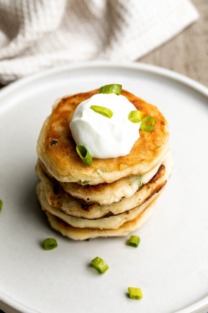 Mashed potato cakes are light and fluffy inside, crispy golden outside, and so delicious and flavorful. The best way to use up leftover mashed potatoes! | aheadofthyme.com