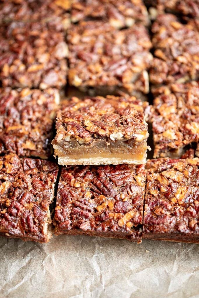 Pecan pie bars are the best and easiest way to enjoy the flavors of pecan pie but with half the effort and in a handheld bite-sized form. | aheadofthyme.com