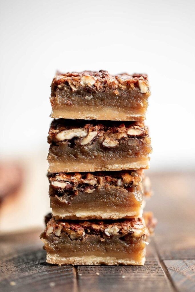 Pecan pie bars are the best and easiest way to enjoy the flavors of pecan pie but with half the effort and in a handheld bite-sized form. | aheadofthyme.com