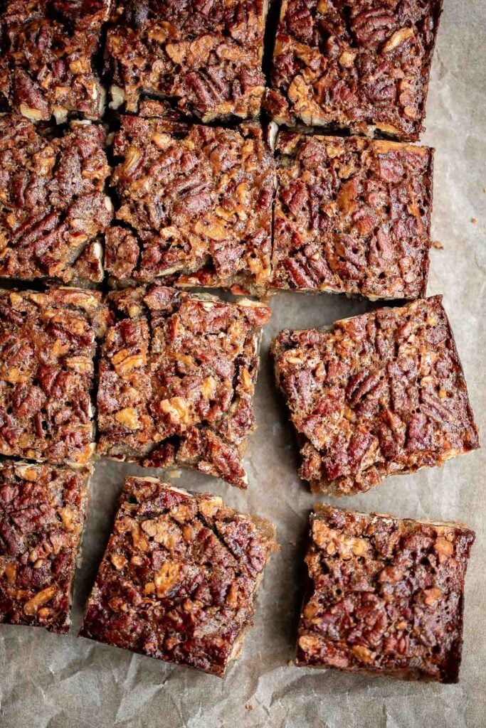Pecan pie bars are the best and easiest way to enjoy the flavors of pecan pie but with half the effort and in a handheld bite-sized form. | aheadofthyme.com