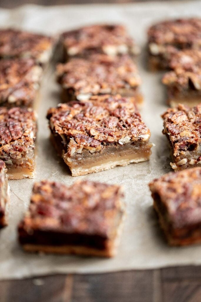 Pecan pie bars are the best and easiest way to enjoy the flavors of pecan pie but with half the effort and in a handheld bite-sized form. | aheadofthyme.com
