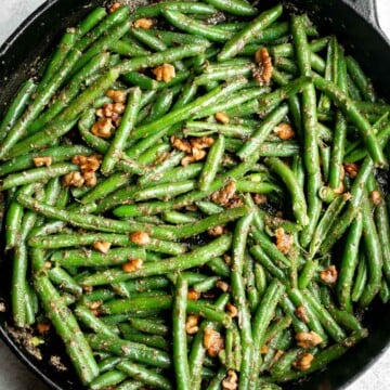 Pesto green beans is a simple side dish that is quick and easy to make in under 10 minutes, tossed in buttery toasted walnuts and pesto. So delicious. | aheadofthyme.com