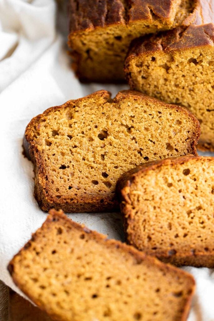 Pumpkin bread is fluffy, moist, and delicious. This classic fall loaf cake is loaded with real pumpkin and seasonal spices like cinnamon and ginger. | aheadofthyme.com